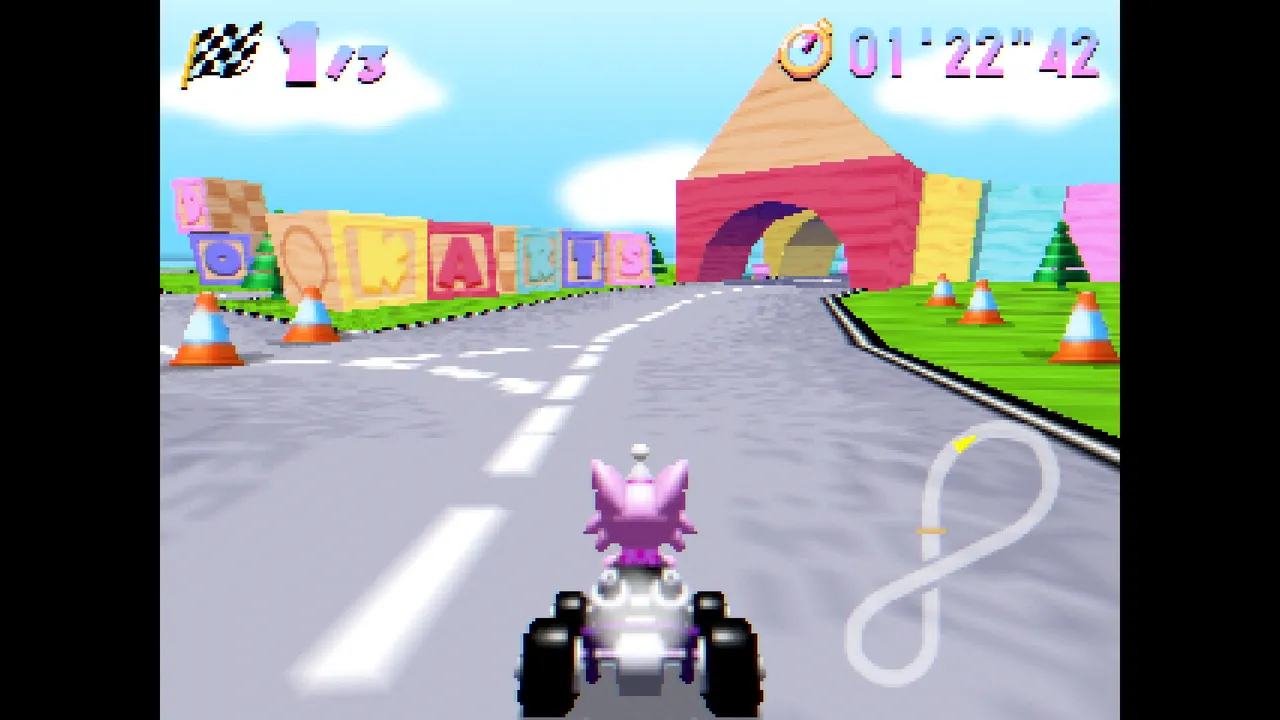 Kitty Kart 64 screenshot: a pink cat in a kart on a grey road towards a bright toy-block archway, in low-poly N64 style
