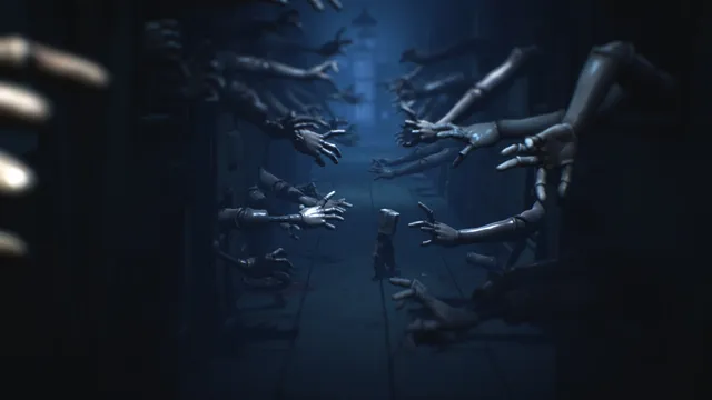 Mono walks down a dark hospital corridor lined with dozens of mannequin arms reaching out from both sides