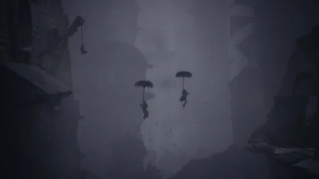 Little Nightmares III screenshot: the two children float down a grey misty chasm holding umbrellas