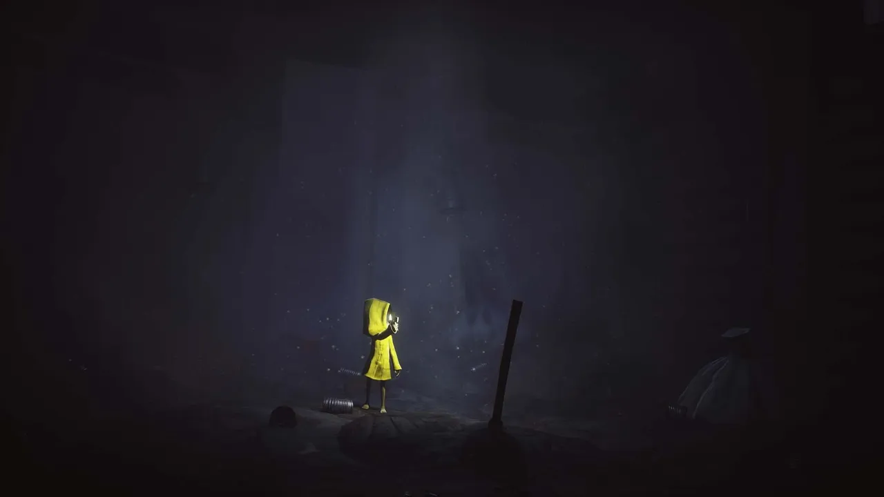 Six in her yellow raincoat lights a tiny flame in a vast dark misty room, a sack and debris barely visible around her
