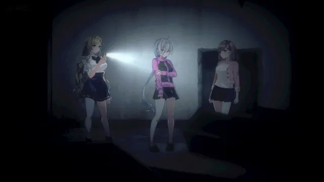 Livestream 2 screenshot: the three streamers stand together in a bare concrete room, one lighting it with her phone