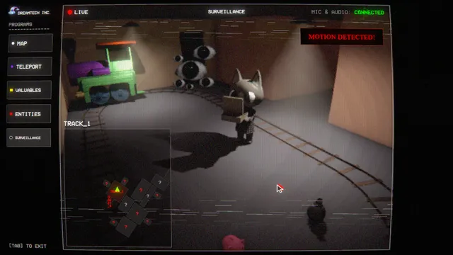 The in-game laptop's security camera feed, showing a player near a toy train and a cluster of eyes, with a motion detected alert and map