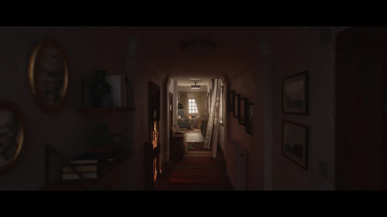 A dim hallway in a family home lined with framed pictures, leading to a lit living room
