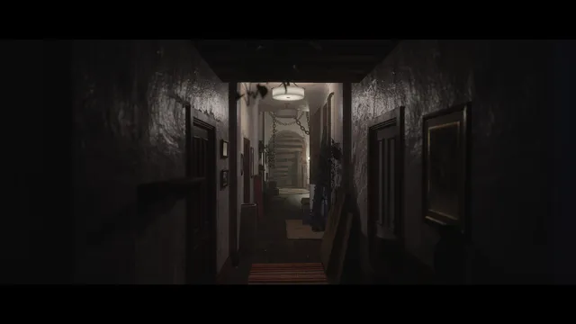 The same house's hallway gone dark, with chains hanging across the stairway at the end