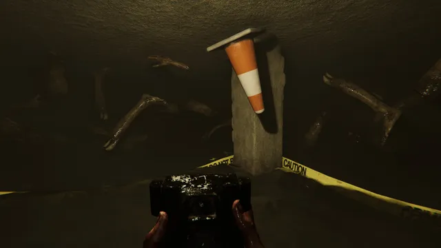 MADiSON screenshot: a bloody hand holds an old instant camera in a cellar full of twisted limbs and caution tape