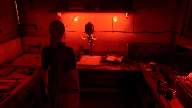 Martha Is Dead screenshot: Giulia stands at the enlarger in a darkroom lit red, with trays and bottles on the tiled benches
