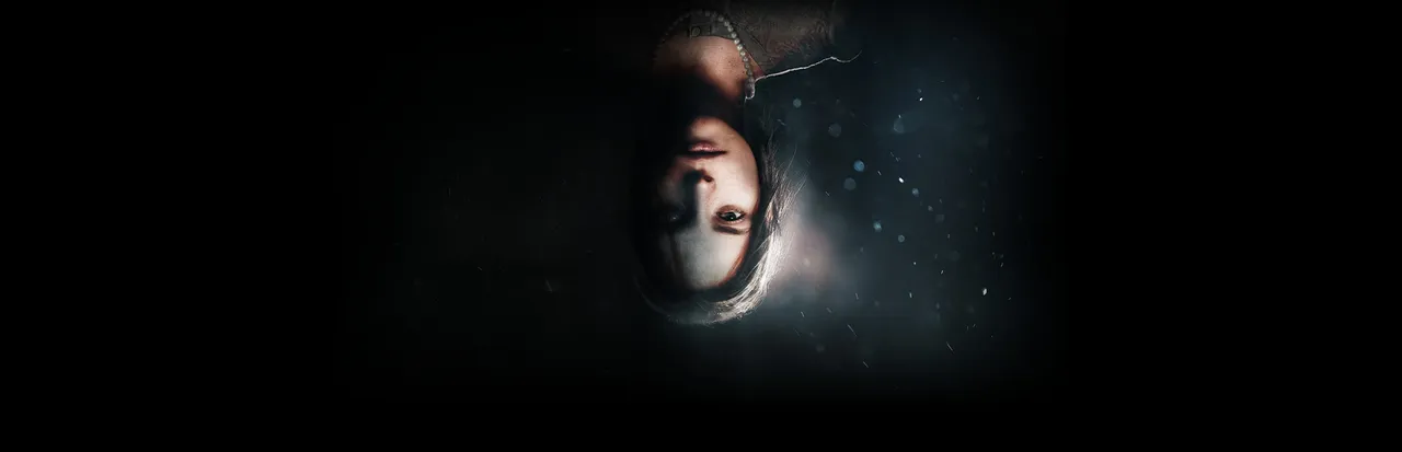 Martha Is Dead key art: the upside-down face of a young woman with a pearl necklace, as if seen through dark water