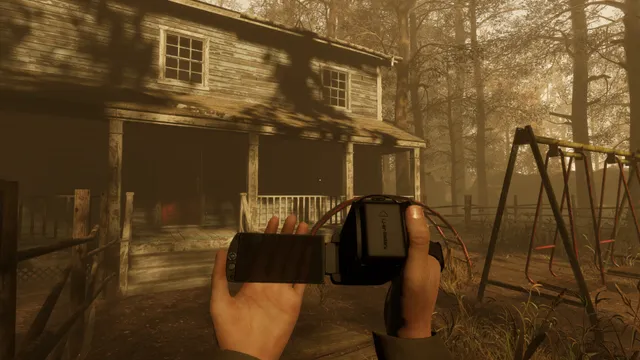 Martha's Dolls 2: first-person view of hands holding a video camera in front of a run-down wooden house and an old swing set in the woods