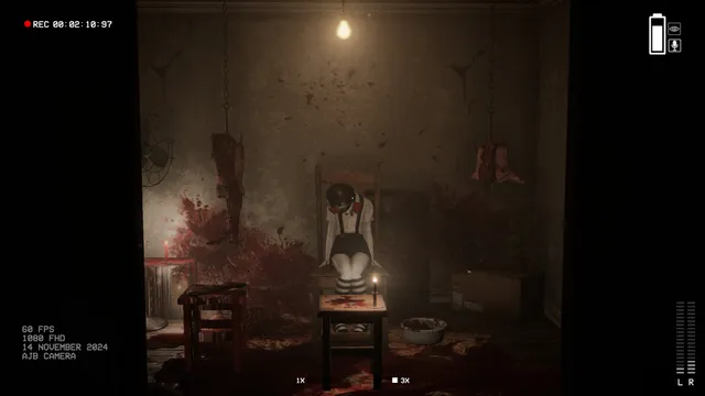 Camera recording view of a room with a doll seated on a chair before a candle and a figure hanging above it