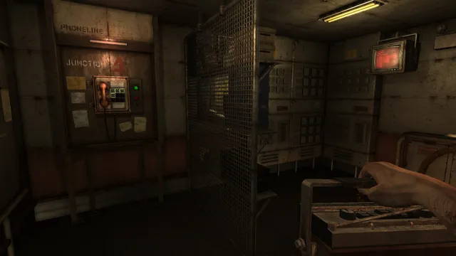 Monstrum screenshot: a phone junction box and a caged room on the ship lit by a yellow strip light