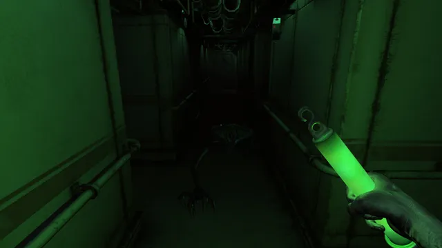 Monstrum screenshot: a creature with long spindly legs stands at the end of a ship corridor lit green by a glow stick in your hand