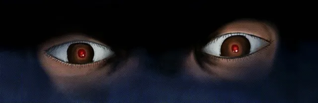 Murder House key art: a pair of wide staring eyes with small red pupils looking out of the dark