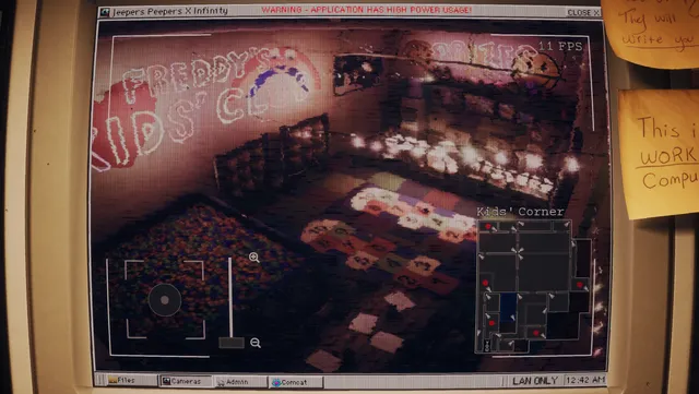 The camera program on the old monitor showing a kids' corner with a ball pit, with a map of the building