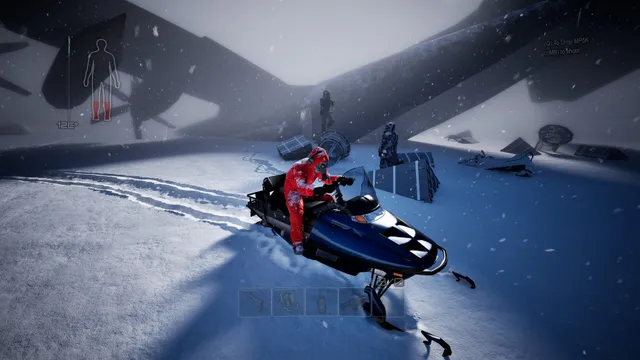 A player in a red suit on a snowmobile in the snow, beside crates and two figures at a crashed aircraft