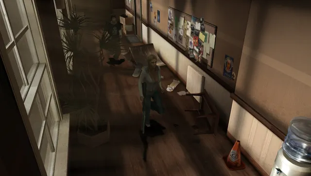 A student walking down a college hallway with a toppled chair and scattered papers, another behind her