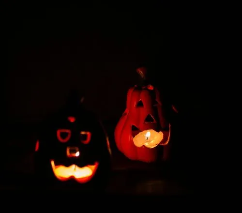 One Halloween Night: two carved jack-o'-lanterns glowing in the dark