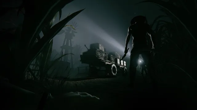 Outlast 2 screenshot: a silhouetted cultist with a machete and flashlight searches a cornfield at night