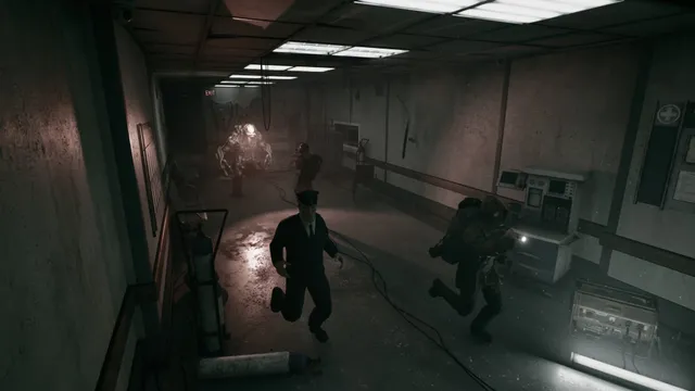Players flee down a dim hospital corridor as a pale, hunched monster charges after them