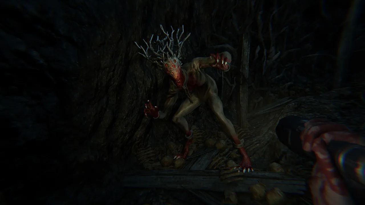 A pale, root-headed demonic creature crouching in a dark cave of roots as the player holds a flashlight