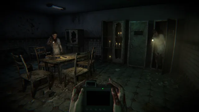 A dim tiled room with a table and chairs, a figure with a flashlight at the back, while the player holds a camera