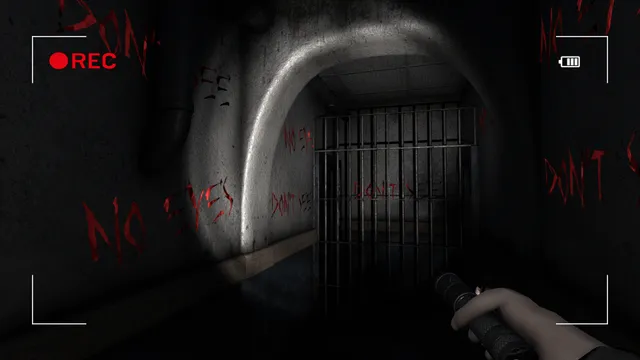 Paranormal Entities screenshot: red writing scrawled across asylum walls around a barred gate