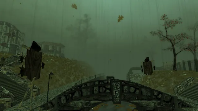Pathologic Classic HD screenshot: ragged scarecrow figures on a hillside above a stone bridge in green fog and rain
