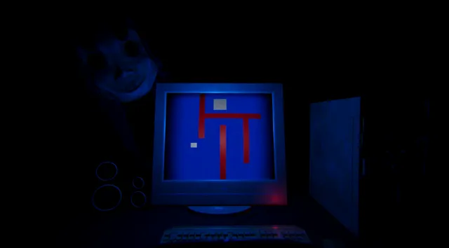 Play With Him screenshot: an old computer monitor glows blue with a red-walled maze game while a pale masked face looms in the dark beside it