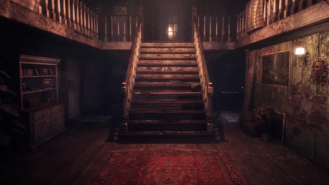 The mansion's entrance hall with a twin wooden staircase, a red rug and blood on the wall beside a mask