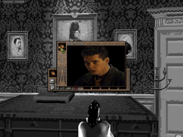 First-person view in a wallpapered room of the mansion, with a video window of Adam Randall speaking