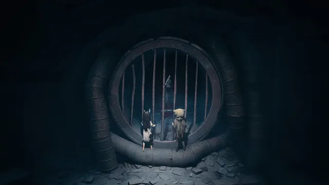 The brother and sister stand at a barred round grate inside a dark tunnel of pipes