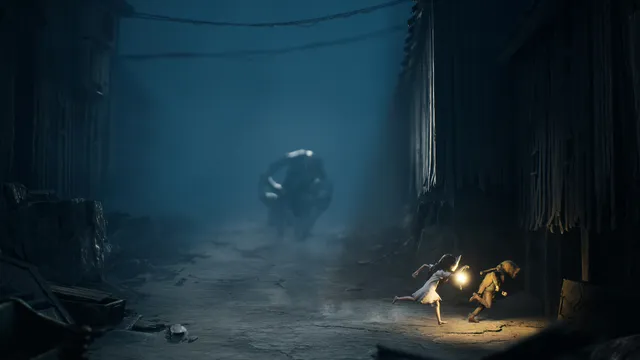 A girl in a white dress holding a lantern runs with a boy in a sack mask down a foggy alley as a huge hunched creature follows behind