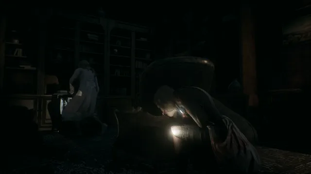 Remothered: Tormented Fathers screenshot: Rosemary hides behind an armchair in a dark library while a figure in a long dress searches the shelves