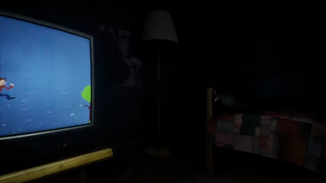 The CRT at an angle with a floor lamp, a poster and a patchwork-covered bed in the dark behind it
