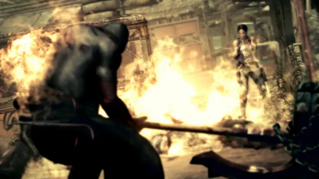 Resident Evil 5 screenshot: the axe-wielding executioner silhouetted against an explosion as Sheva stands behind