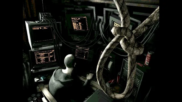 A grey figure sits at a bank of old monitors while a noose hangs in the foreground