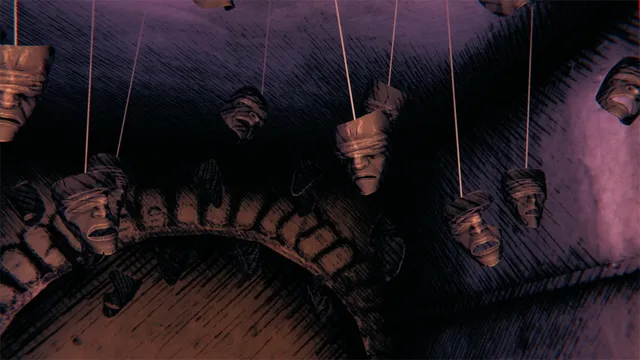 Carved wooden masks hang on strings from the ceiling of a dark stone room