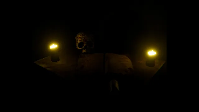 Scauage: a skull between two lit candles on a table in the dark