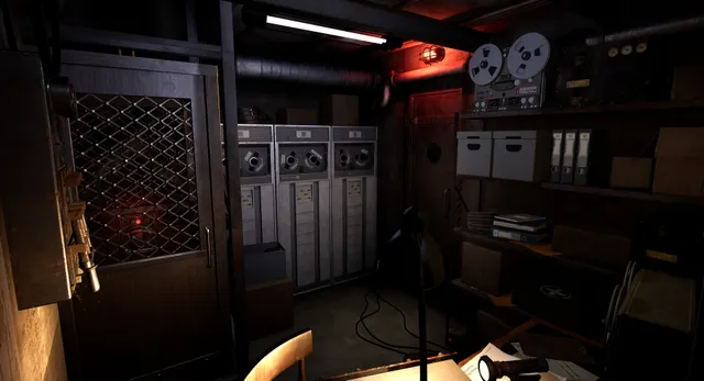 Shattered Lights: a wire-mesh door and old computer cabinets beside a red warning light