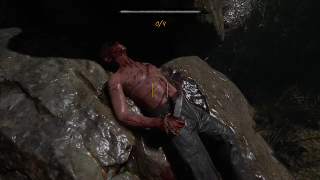 A bloodied body lying on a rock, marked for examination