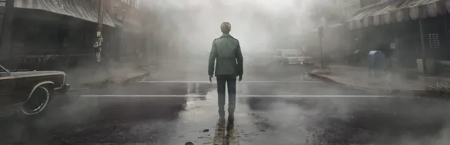 James stands with his back to us in the middle of a fog-filled Silent Hill street, abandoned cars and shopfronts fading into grey mist
