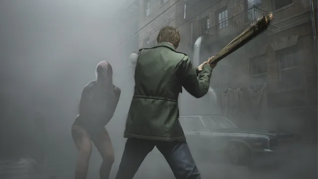 James swings a wooden plank at a writhing, limbless Lying Figure monster in a foggy alley beside a brick building