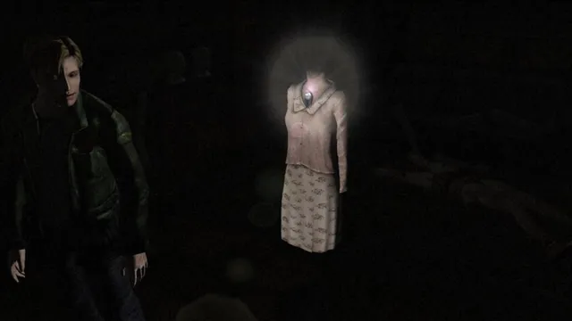 James in the dark beside a glowing, headless dress on a mannequin