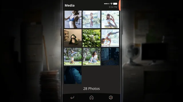 SIMULACRA 2 screenshot: the phone's media gallery of 28 photos, mostly yoga and travel pictures