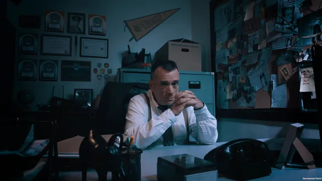 SIMULACRA 2 screenshot: a detective in suspenders sits at his desk under a wall of newspaper clippings and awards