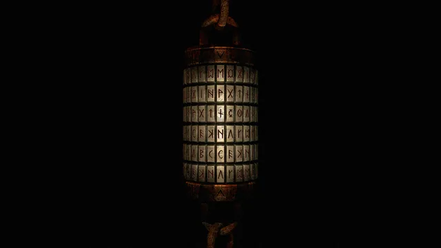 A metal cylinder puzzle of rotating lettered rings hanging on a chain in the dark
