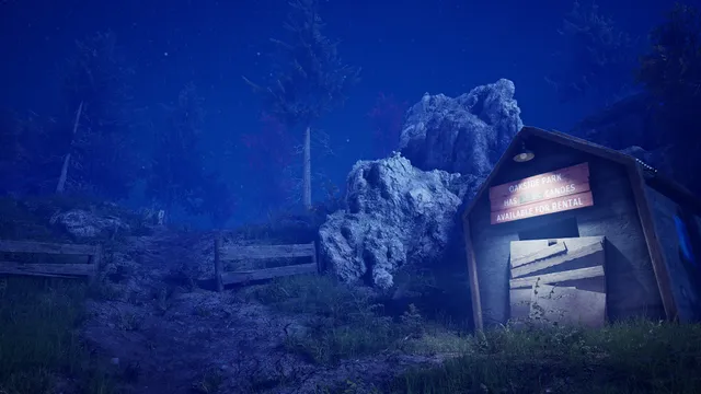 A boarded-up wooden building beside large rocks on a hillside at night