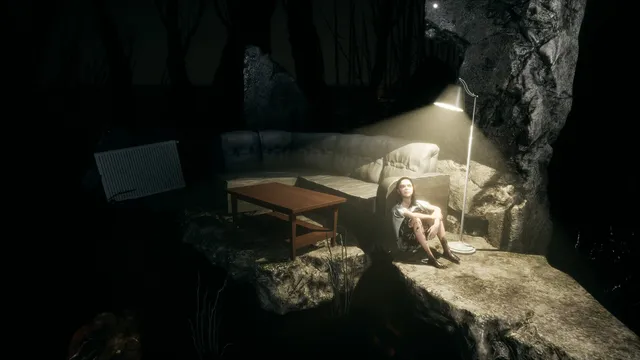 A girl sitting against a sofa under a lamp on a rock in the dark forest