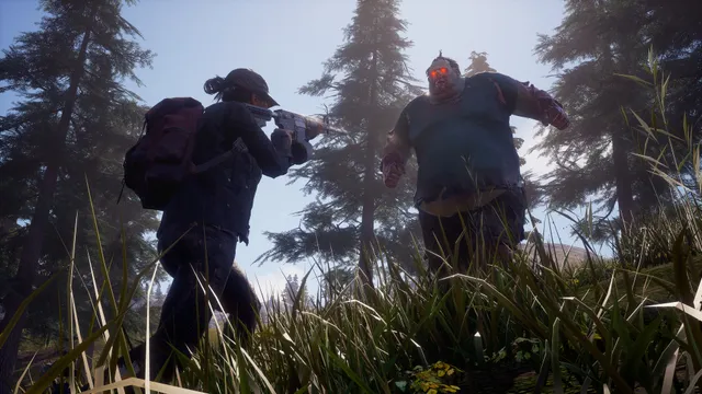 State of Decay 2 screenshot: a survivor with a backpack aims a rifle at a red-eyed plague zombie in the woods