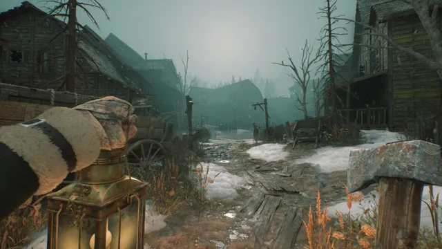 First-person view holding a lantern and a hammer on a muddy, snowy street of ramshackle wooden houses in fog