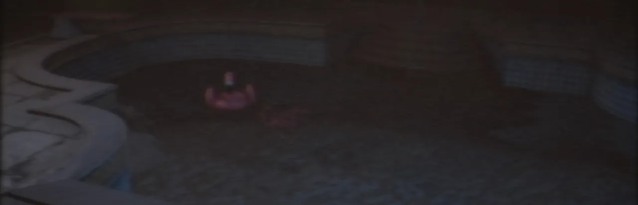 The Backrooms 1998 key art: a dark, empty tiled pool room with a pink inflatable ring floating in the gloom